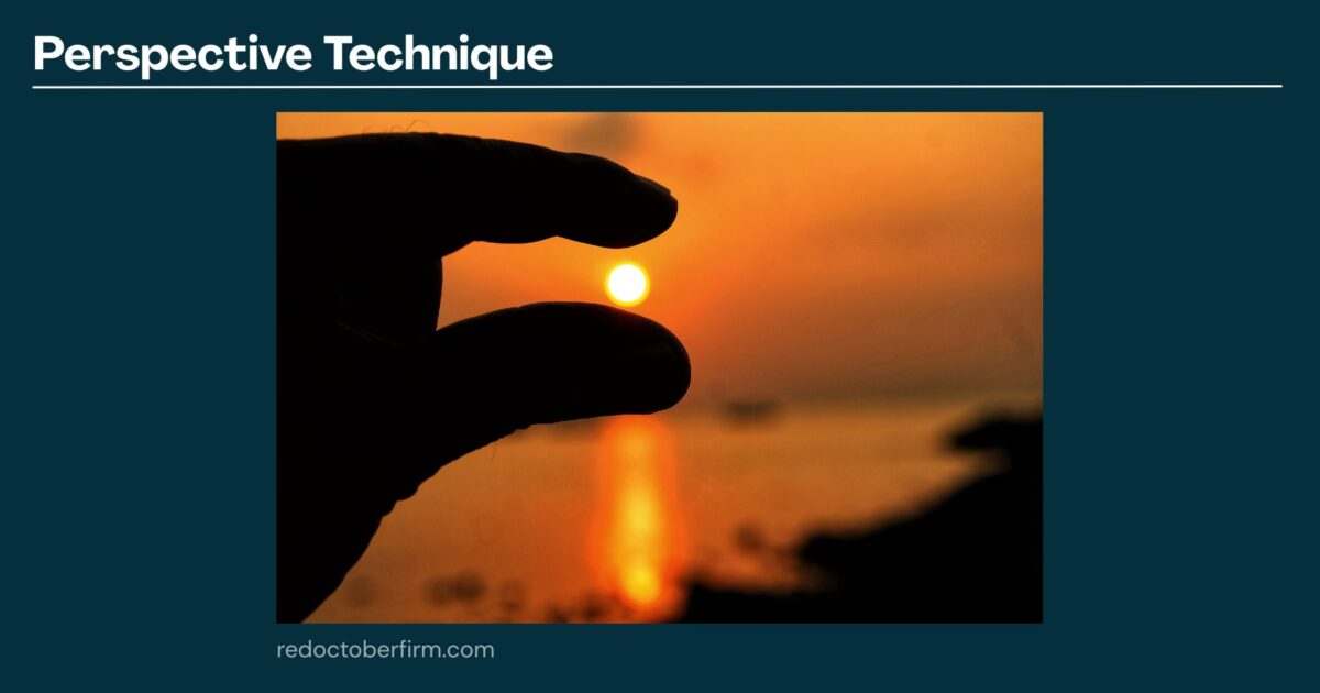 22 Basic Photography Techniques You Need To Level Up! A Hand Positioned To Appear As If It Is Pinching The Setting Sun Over A Calm Body Of Water, Demonstrating A Perspective Photography Technique.