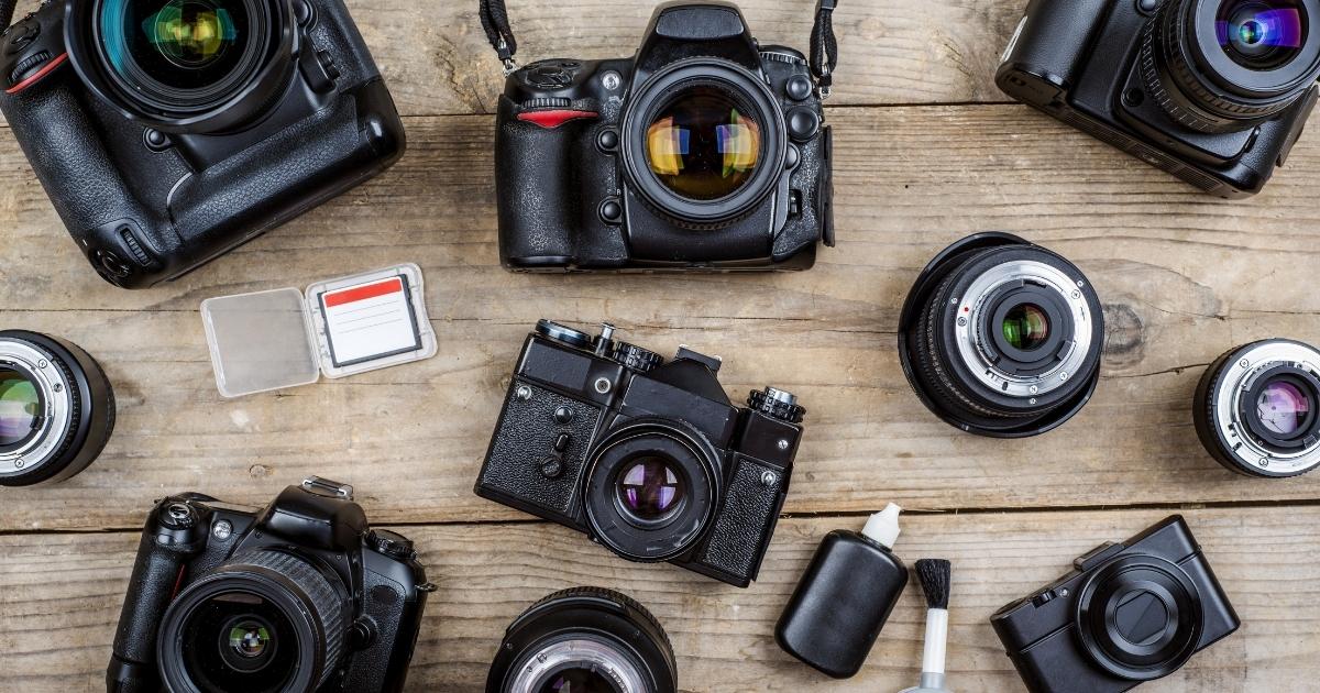 Does Photography Take Skill Or Talent (What You Need To Know) A Collection Of Cameras And Accessories Arranged On A Wooden Table.