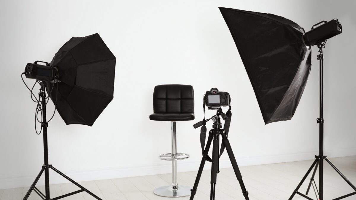 Photography Lighting Setup For Beginners (An Easy Guide) A Photography Studio Equipped With A Tripod, Lights, And A Chair For The Perfect Photography Lighting Setup.