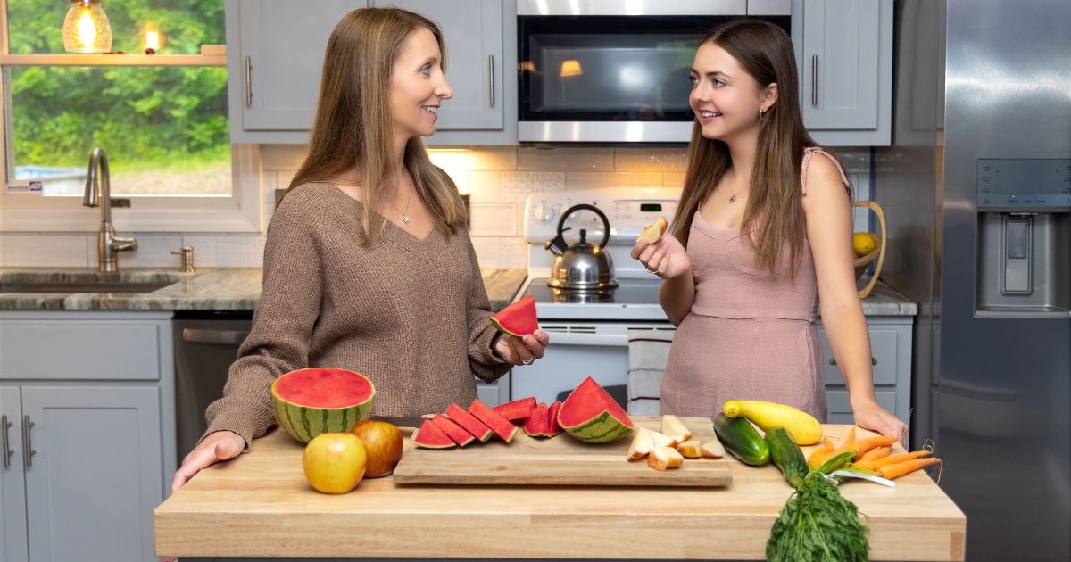 Photography At Home: Tips For Capturing Great Shots Indoors Two Women Cooking At Home In Front Of A Cutting Board.