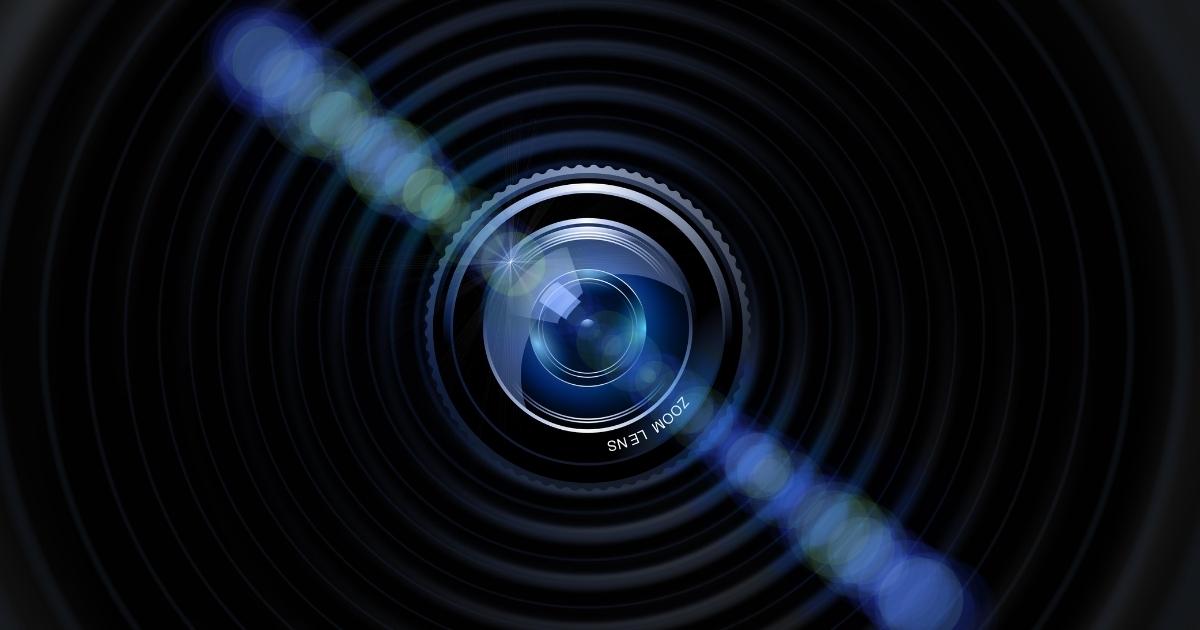 Photo Session Vs Photoshoot: What'S The Difference? A Camera Lens On A Black Background For A Photo Shoot.