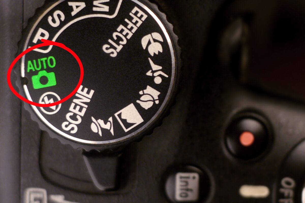 Auto Vs. Manual Mode: What Photographers Should Know A Close Up Of A Camera With An Auto Button On It.