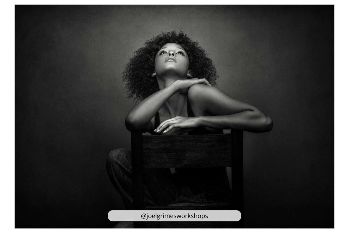 Why Photography Is An Art (My Take Take On The Matter) An Artistic Black And White Photo Capturing A Woman Gracefully Posing On A Chair.