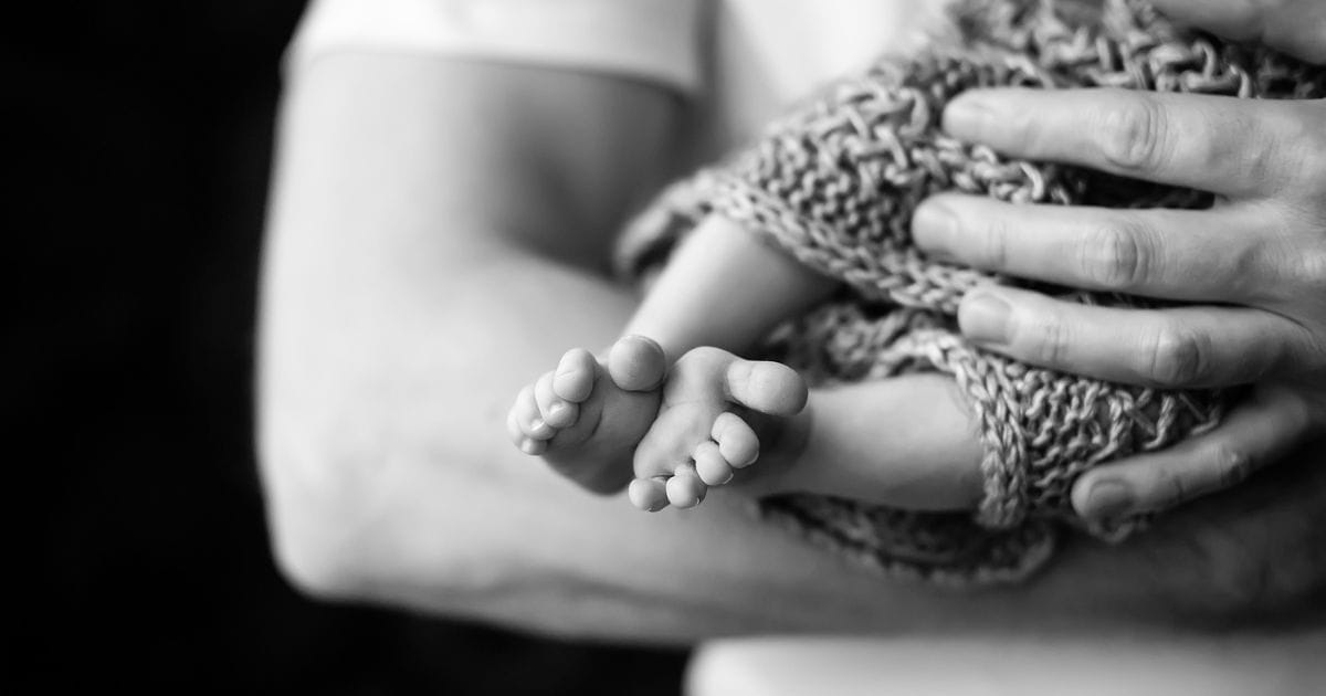 Photography At Home: Tips For Capturing Great Shots Indoors A Black And White Home Photography Of A Man Holding A Baby.