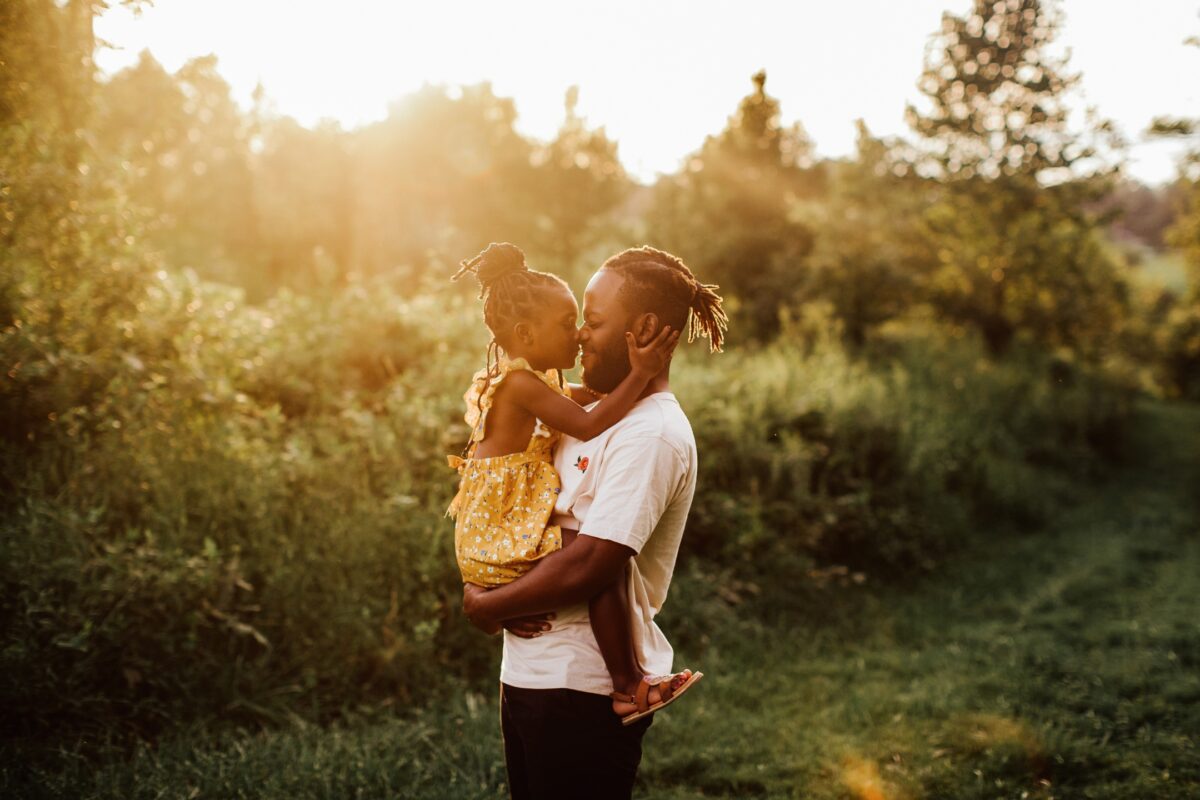 What To Say To Clients During A Photo Session: With Prompts A Man And His Daughter Striking Poses In A Field At Sunset, Guided By Helpful Posing Prompts For An Engaging Photo Session.
