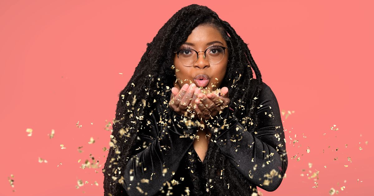 Best Photography Poses For Pictures (From A Pro Photographer) A Woman With Dreadlocks Striking Poses And Blowing Out Gold Confetti.