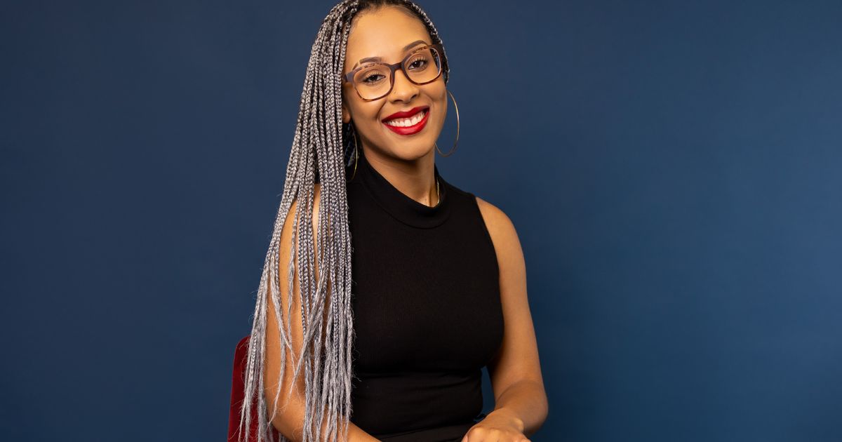 Best Photography Poses For Pictures (From A Pro Photographer) A Woman With Glasses And Braids Posing For Pictures.