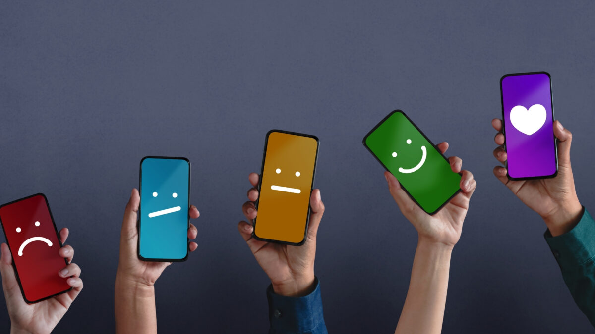 22 Ways To Market Your Photography Business For More Clients A Group Of People Holding Smartphones With Different Colored Smiley Faces On Them, Providing Feedback On Photos.