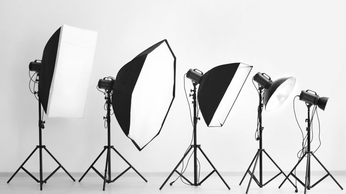 Perfect Indoor Photos And The Camera Settings You'Ll Need A Black And White Photo Featuring A Group Of Photo Studio Lights, Creating The Perfect Ambiance For Indoor Photos.