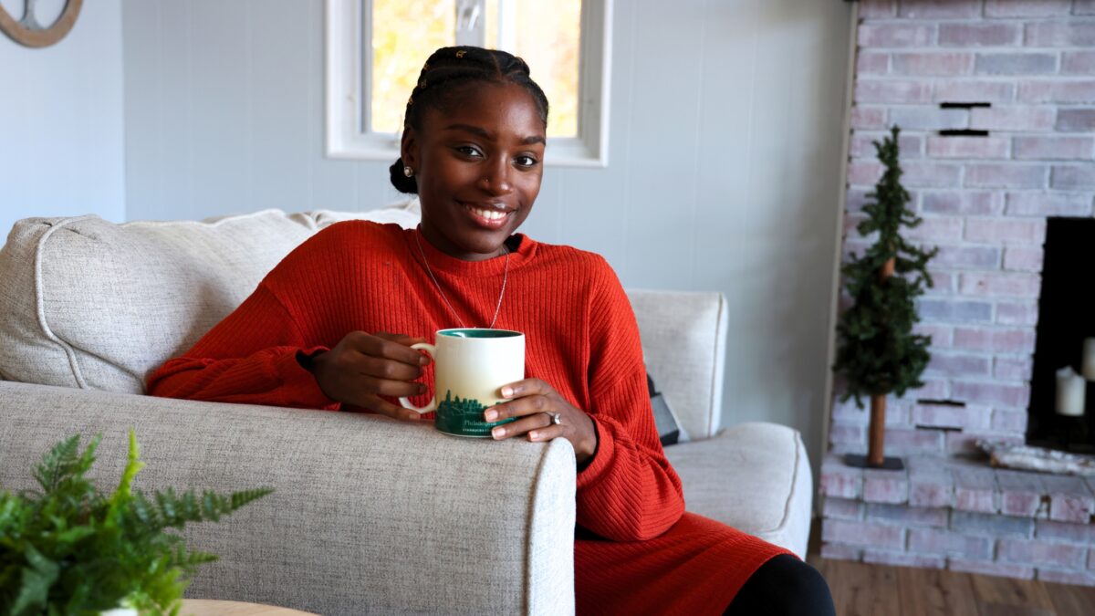 17 Reasons Why Your Business Needs Brand Photography A Woman Sitting On A Couch Holding A Coffee Mug, Showcasing One Of The Props To Bring To A Photoshoot.