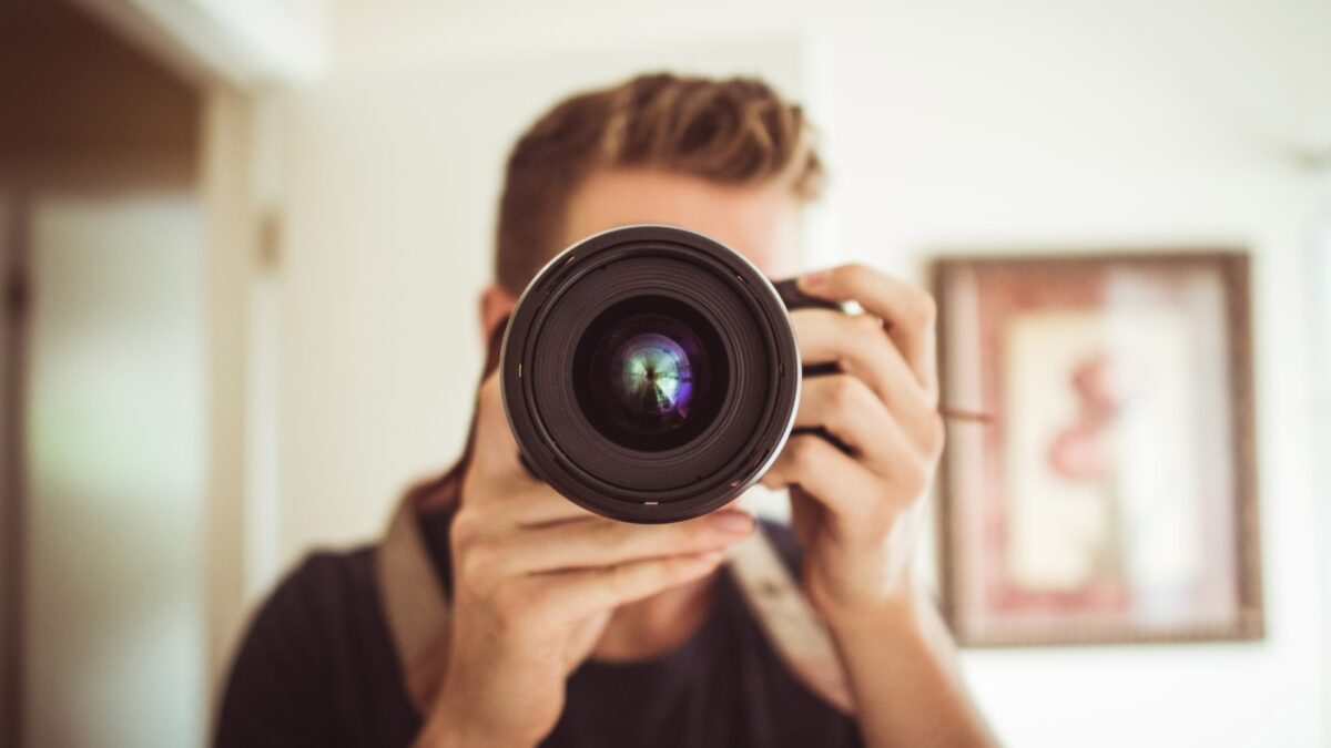 Portrait Photography Tips For Beginners A Man Is Capturing A Portrait With His Camera, Applying Professional Photography Tips.