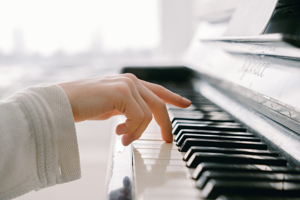 Composition In Photography And What You Need To Know A Woman'S Hand Is Meticulously Playing A Piano, Capturing A Stunning Composition In Photography.