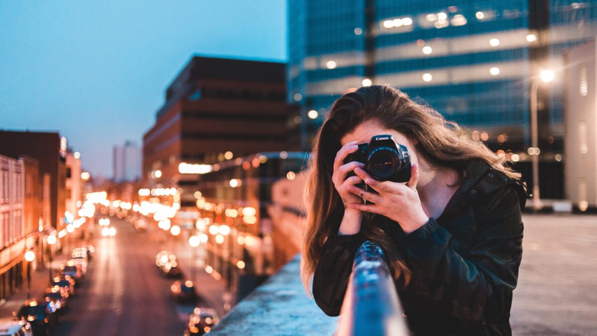 How To Learn And Improve From Mistakes As A Photographer A Woman Making Mistakes As A Photographer While Capturing A City At Night.