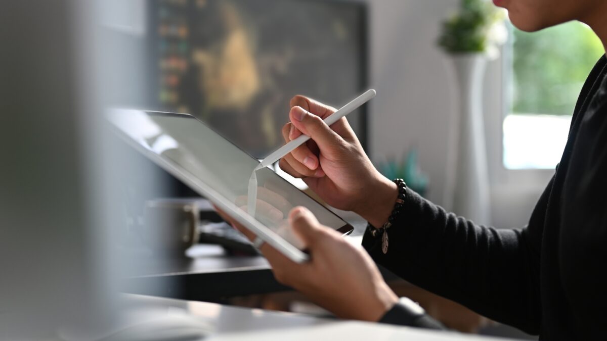 Simple Photo Editing Tips To Get Better-Looking Photos A Person Using A Tablet To Edit Photos With A Pen.