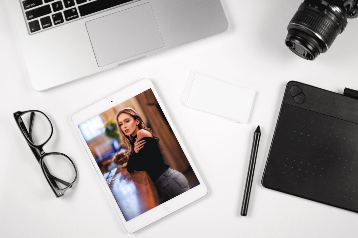 How To Turn Photos Into Art An Ipad With A Photo Of A Woman Next To A Laptop And Camera, Capable Of Turning Photos Into Art.