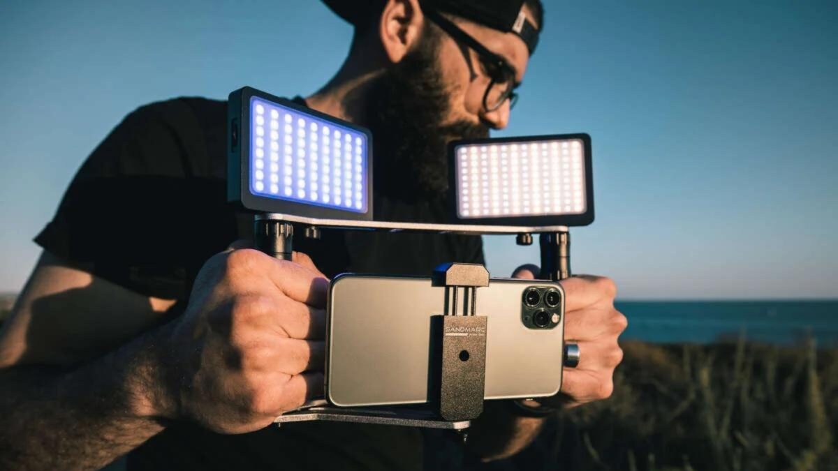 How To Take Professional-Looking Photos With Your Smartphone A Bearded Man Capturing Photos With His Smartphone Camera, Equipped With A Light Attachment.