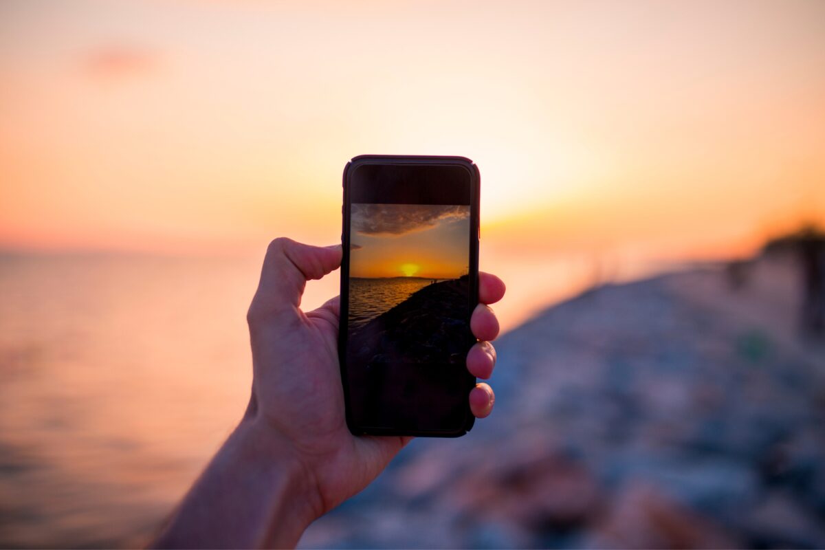Mobile Photography Tips That'Ll Help You Take Better Photos A Person Using Mobile Photography To Capture A Stunning Sunset.
