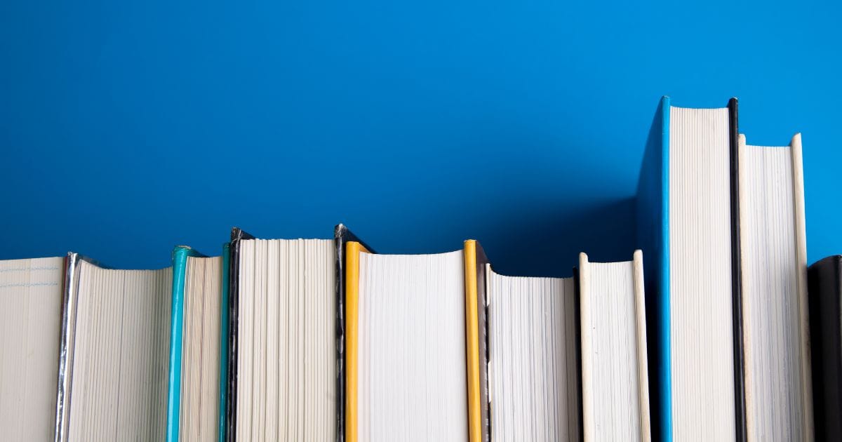 Photography For Beginners (How To Take Pictures Like A Pro) A Stack Of Books On A Blue Background, Perfect For Photography Beginners.