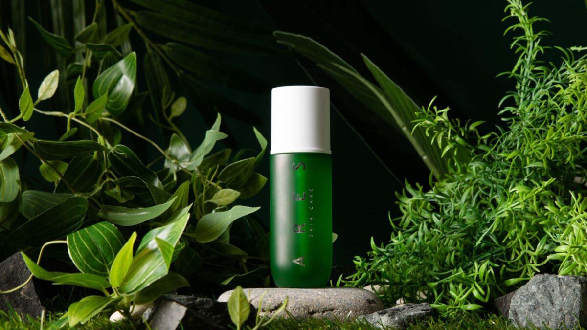 20 Cool Diy Backdrop Ideas For Your Next Photoshoot A Green Bottle Nestled Among Lush Plants And Rocky Backdrop, Perfect For Photography Ideas.