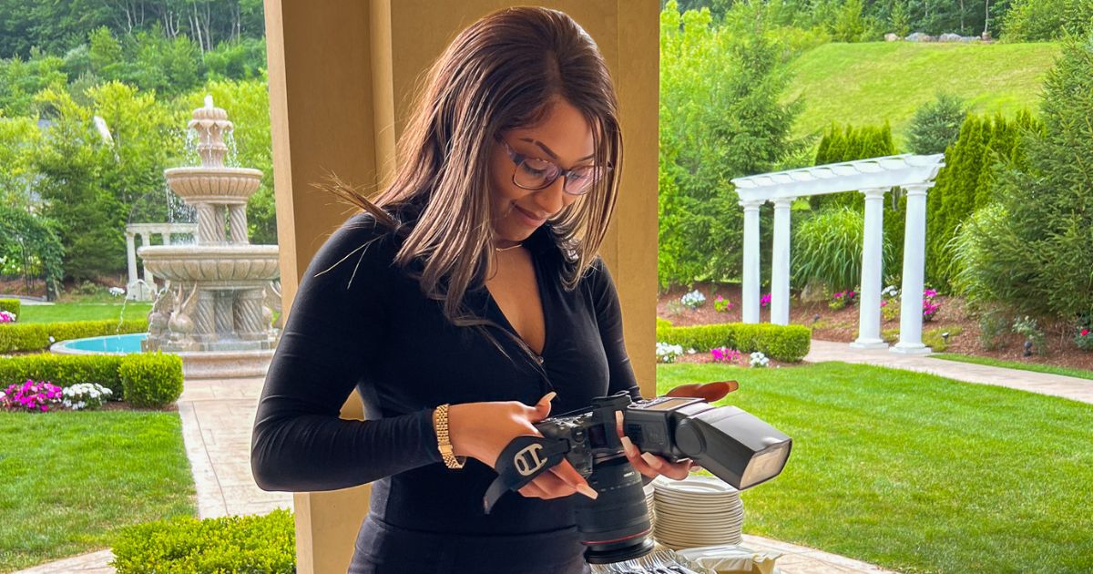 Photography For Beginners (How To Take Pictures Like A Pro) A Woman Capturing Photographs In Front Of A House, Demonstrating Photography For Beginners.