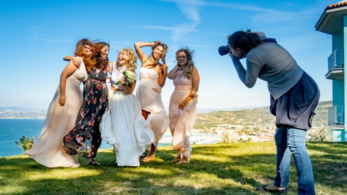 How To Build A Photography Portfolio As A New Photographer A Bride And Her Bridesmaids Pose For A Photo.