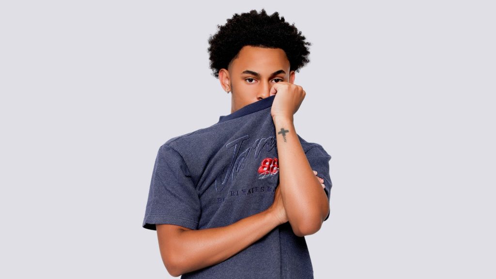 How To Take Pictures As An Introvert (The Easy Way) A Guy Holding Shirt Taking Pictures As An Introvert