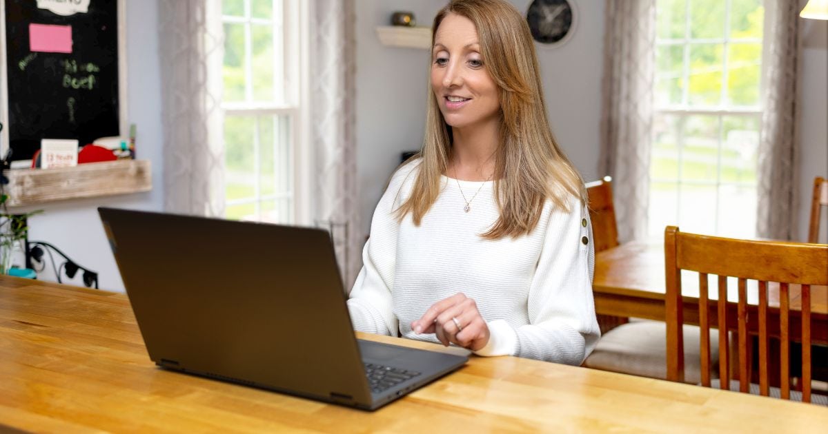Photography At Home: Tips For Capturing Great Shots Indoors A Woman At Home Using Her Laptop For Photography.