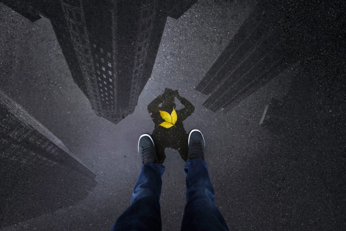 Mobile Photography Tips That'Ll Help You Take Better Photos A Person'S Feet Standing On Top Of A Building, Capturing An Amazing Mobile Photography Shot With A Yellow Bird Perched Nearby.