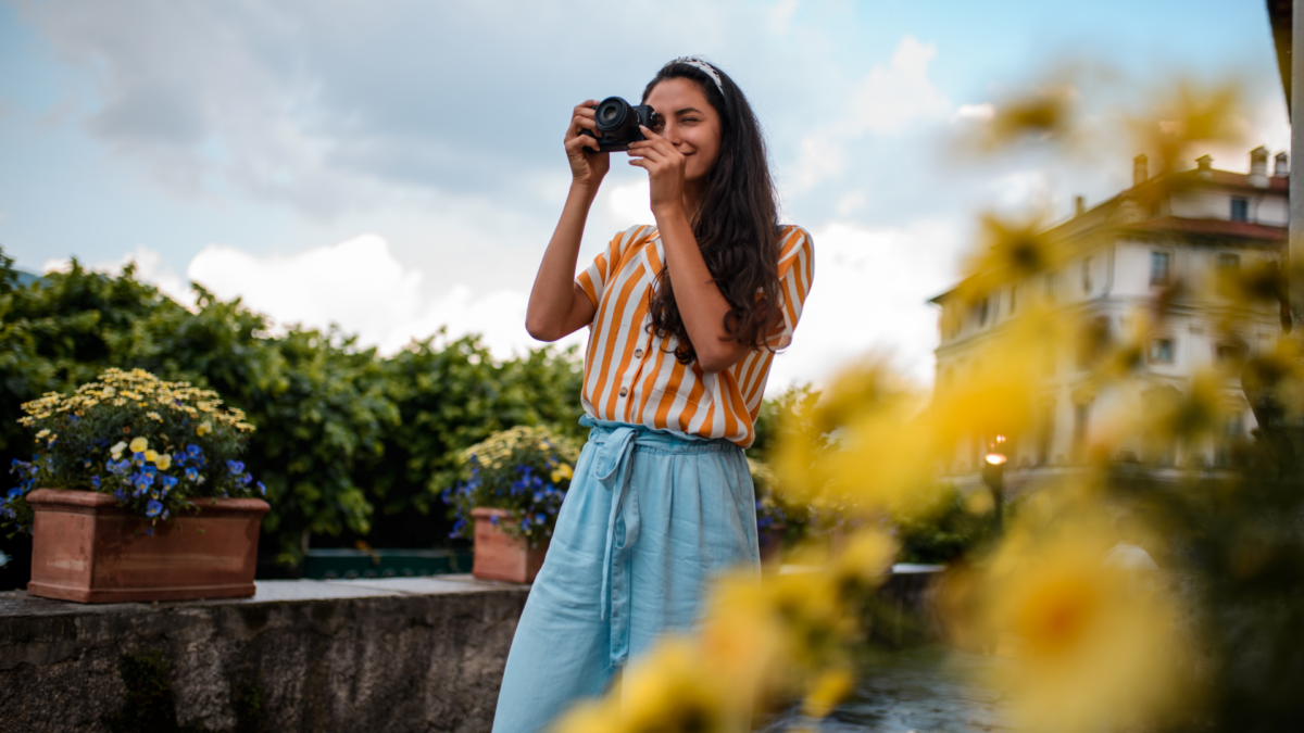 Instantly Take Better Photos Like The Pros (No Fancy Gear Needed) Photographer Taking Pictures Of Flowers